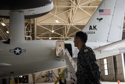 Japan Air Self-Defense Force senior enlisted advisor Warrant Officer Masahiro Yokota looks at an E-3 Sentry assigned to the 962nd Airborne Air Control Squadron at Joint Base Elmendorf-Richardson, Alaska, June 19, 2018. During his visit, Yokota toured the installation and oversaw JASDF Airmen working alongside American forces during Pacific Air Forces’ premier air combat exercise, Red Flag-Alaska, iteration 18-2.