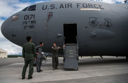 U.S. Air Force Master Sgt. Spencer Stacey, 517th Airlift Squadron operations superintendent, gives a tour of a C-17 Globemaster III to Japan Air Self-Defense Force senior enlisted advisor Warrant Officer Masahiro Yokota at Joint Base Elmendorf-Richardson, Alaska, June 19, 2018. During his visit, Yokota toured the installation and oversaw JASDF Airmen working alongside American forces during Pacific Air Forces’ premier air combat exercise, Red Flag-Alaska, iteration 18-2.