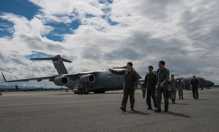 U.S. Air Force Master Sgt. Spencer Stacey, 517th Airlift Squadron operations superintendent, gives a tour of the flightline to Japan Air Self-Defense Force senior enlisted advisor Warrant Officer Masahiro Yokota at Joint Base Elmendorf-Richardson, Alaska, June 19, 2018. During his visit, Yokota toured the installation and oversaw JASDF Airmen working alongside American forces during Pacific Air Forces’ premier air combat exercise, Red Flag-Alaska, iteration 18-2.