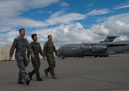 Japan Air Self-Defense Force senior enlisted advisor Warrant Officer Masahiro Yokota (left) walks the flightline at Joint Base Elmendorf-Richardson, Alaska, June 19, 2018. During his visit, Yokota toured the installation and oversaw JASDF Airmen working alongside American forces during Pacific Air Forces’ premier air combat exercise, Red Flag-Alaska, iteration 18-2.