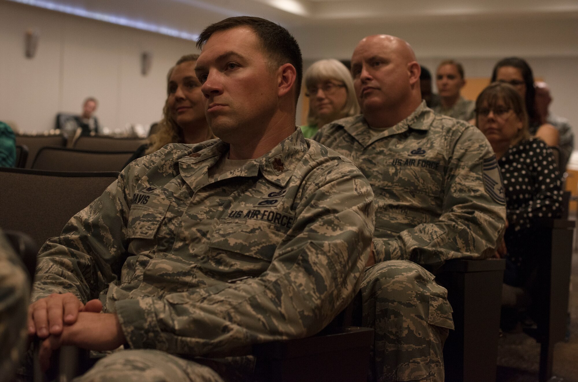 U.S. Air Force Maj. Ross Davis, 87th Wing Staff Agency company commander, and U.S. Air Force Chief Master Sgt. Robert Laufer, 87th WSA superintendent, listen to a speech during the Storytellers convention on Joint Base McGuire-Dix-Lakehurst, N.J., June 20, 2018. Joint Base MDL leaders attended the event to show their support for the community learning resiliency by sharing and relating their own experiences with others. (U.S. Air Force photo by Airman Ariel Owings)