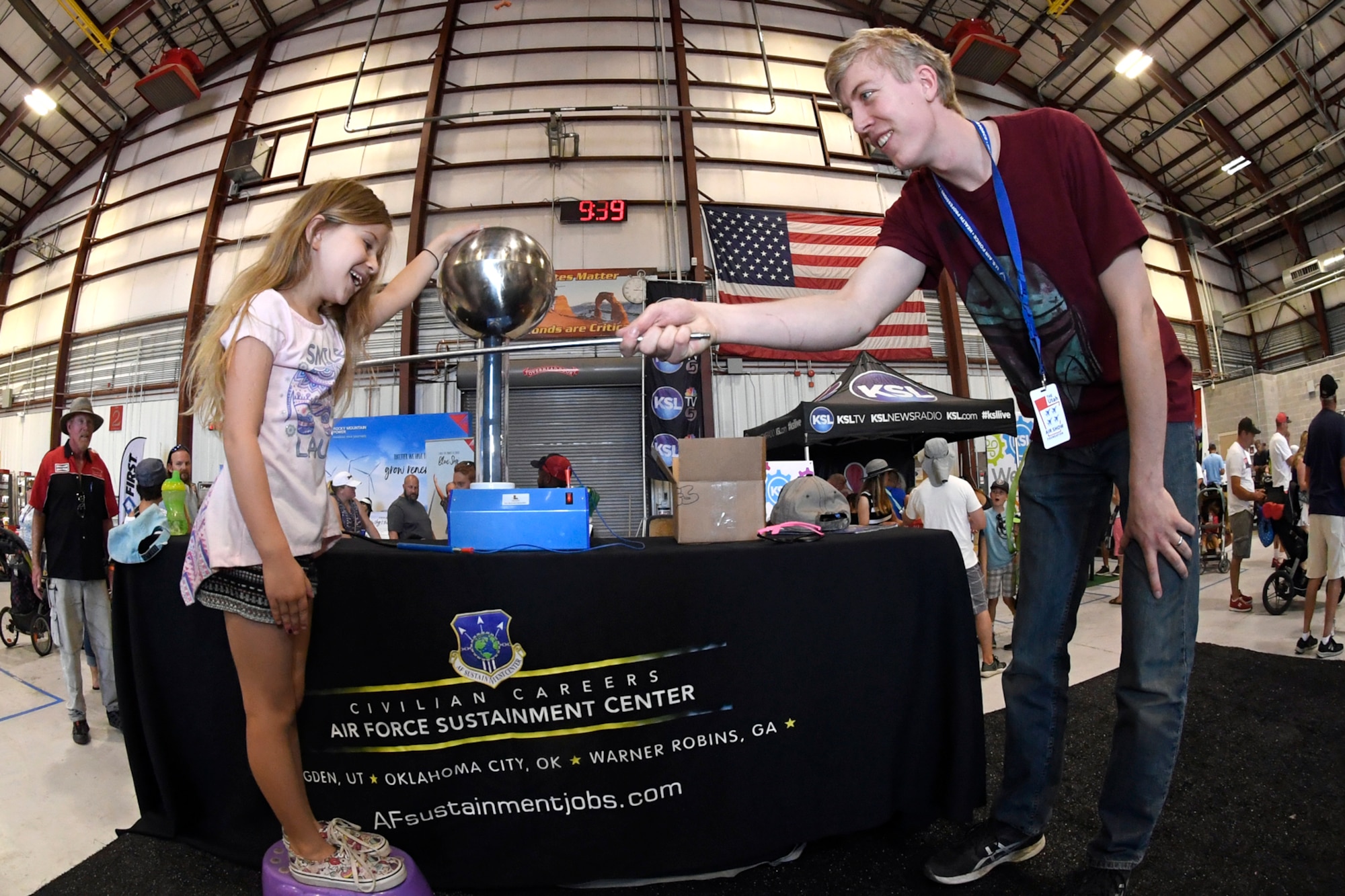 Tim Trimble (right), a student intern at the Hill Aerospace Museum, demonstrates electricity behavior to Morgan Craddock during the Warriors Over the Wasatch Air and Space Show June 24, 2018, at Hill Air Force Base, Utah. The display was one of  numerous exhibits and activities associated with STEM City at the Hill Air Show June 23-24, an area dedicated to encouraging students and educating parents about opportunities in science, technology, engineering and math.(U.S. Air Force Photo by Todd Cromar)