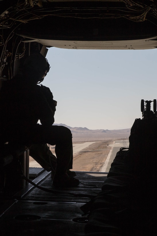 Cpl. Chase Clark, a tiltrotor crew chief with Marine Medium Tiltrotor Squadron 764, Marine Aircraft Group 41, 4th Marine Aircraft Wing, looks out the rear of an MV-22B Osprey during Integrated Training Exercise 4-18, at Marine Corps Air Ground Combat Center Twentynine Palms, Calif., June 23, 2018. VMM-764, known as “moonlight,” is based out of Marine Corps Air Station Miramar and provided air combat element support to Marine Air Ground Task Force 23 during ITX 4-18. (U.S. Marine Corps photo by Lance Cpl. Samantha Schwoch/released)