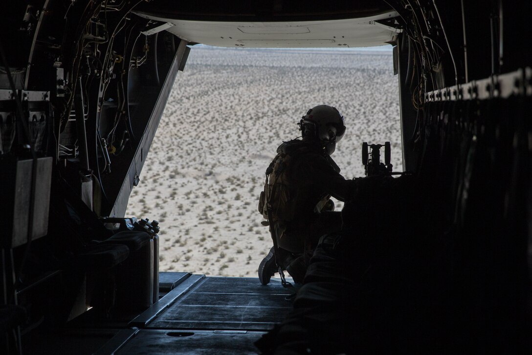 Cpl. Chase Clark, a tiltrotor crew chief with Marine Medium Tiltrotor Squadron 764, Marine Aircraft Group 41, 4th Marine Aircraft Wing, prepares the MV-22B Osprey to board Marines during Integrated Training Exercise 4-18, at Marine Corps Air Ground Combat Center Twentynine Palms, Calif., June 23, 2018. VMM-764, known as “moonlight,” is based out of Marine Corps Air Station Miramar and provided air combat element support to Marine Air Ground Task Force 23 during ITX 4-18. (U.S. Marine Corps photo by Lance Cpl. Samantha Schwoch/released)