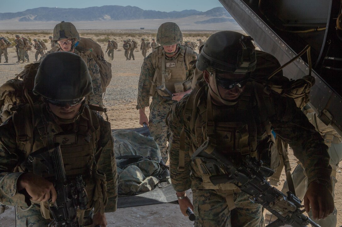 Marines with Weapons Company, 1st Battalion, 25th Marine Regiment, 4th Marine Division, embark an MV-22B Osprey, during Integrated Training Exercise 4-18, at Marine Corps Air Ground Combat Center Twentynine Palms, Calif., June 23, 2018. VMM-764, known as “moonlight,” is based out of Marine Corps Air Station Miramar and provided air combat element support to Marine Air Ground Task Force 23 during ITX 4-18. (U.S. Marine Corps photo by Lance Cpl. Samantha Schwoch/released)