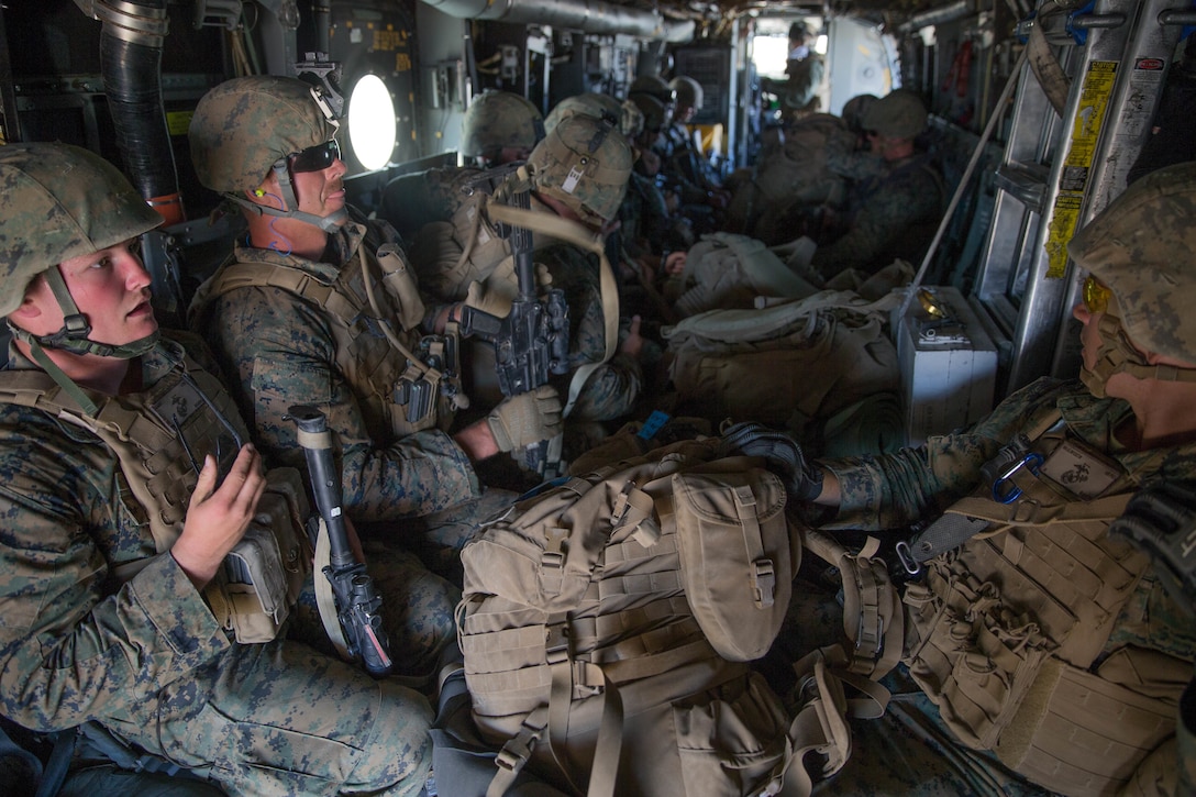 Marines with Weapons Company, 1st Battalion, 25th Marine Regiment, 4th Marine Division, fly in an MV-22B Osprey for an air insert, during Integrated Training Exercise 4-18 at Marine Corps Air Ground Combat Center Twentynine Palms, Calif., June 23, 2018. VMM-764, known as “moonlight,” is based out of Marine Corps Air Station Miramar and provided air combat element support to Marine Air Ground Task Force 23 during ITX 4-18. (U.S. Marine Corps photo by Lance Cpl. Samantha Schwoch/released)