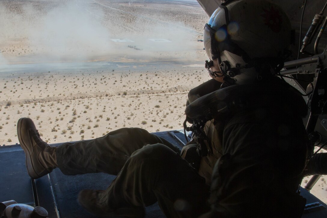 Cpl. Chase Clark, a tiltrotor crew chief with Marine Medium Tiltrotor Squadron 764, Marine Aircraft Group 41, 4th Marine Aircraft Wing, sits on the MV-22B Osprey ramp while conducting aerial assault missions, during Integrated Training Exercise 4-18 at Marine Corps Air Ground Combat Center Twentynine Palms, Calif., June 23, 2018. VMM-764, known as “moonlight,” is based out of Marine Corps Air Station Miramar and provided air combat element support to Marine Air Ground Task Force 23 during ITX 4-18. (U.S. Marine Corps photo by Lance Cpl. Samantha Schwoch/released)