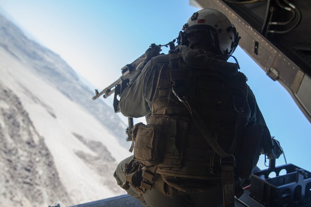 Cpl. Chase Clark, a tiltrotor crew chief with Marine Medium Tiltrotor Squadron 764, Marine Aircraft Group 41, 4th Marine Aircraft Wing, ensures a landing zone is secure before an air assault during Integrated Training Exercise 4-18, at Marine Corps Air Ground Combat Center Twentynine Palms, Calif., June 23, 2018. VMM-764, known as “moonlight,” is based out of Marine Corps Air Station Miramar and provided air combat element support to Marine Air Ground Task Force 23 during ITX 4-18. (U.S. Marine Corps photo by Lance Cpl. Samantha Schwoch/released)