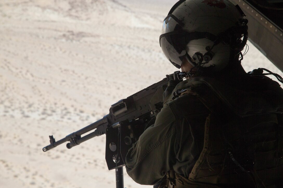 Cpl. Chase Clark, a tiltrotor crew chief with Marine Medium Tiltrotor Squadron 764, Marine Aircraft Group 41, 4th Marine Aircraft Wing, ensures a landing zone is secure before an air assault during Integrated Training Exercise 4-18, at Marine Corps Air Ground Combat Center Twentynine Palms, Calif., June 23, 2018. VMM-764, known as “moonlight,” is based out of Marine Corps Air Station Miramar and provided air combat element support to Marine Air Ground Task Force 23 during ITX 4-18. (U.S. Marine Corps photo by Lance Cpl. Samantha Schwoch/released)