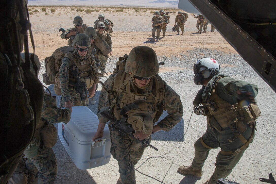 Marines with Alpha Company, 1st Battalion, 25th Marine Regiment, 4th Marine Division, embark an MV-22B Osprey for an air assault operation during Integrated Training Exercise 4-18, at Marine Corps Air Ground Combat Center Twentynine Palms, Calif., June 23, 2018. VMM-764, known as “moonlight,” is based out of Marine Corps Air Station Miramar and provided air combat element support to Marine Air Ground Task Force 23 during ITX 4-18. (U.S. Marine Corps photo by Lance Cpl. Samantha Schwoch/released)