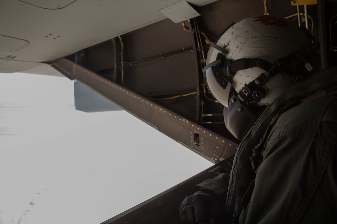 Cpl. Chase Clark, a tiltrotor crew chief with Marine Medium Tiltrotor Squadron 764, Marine Aircraft Group 41, 4th Marine Aircraft Wing, looks out the open ramp of an MV-22B Osprey during Integrated Training Exercise 4-18, at Marine Corps Air Ground Combat Center Twentynine Palms, Calif., June 23, 2018. VMM-764, known as “moonlight,” is based out of Marine Corps Air Station Miramar and provided air combat element support to Marine Air Ground Task Force 23 during ITX 4-18. (U.S. Marine Corps photo by Lance Cpl. Samantha Schwoch/released)