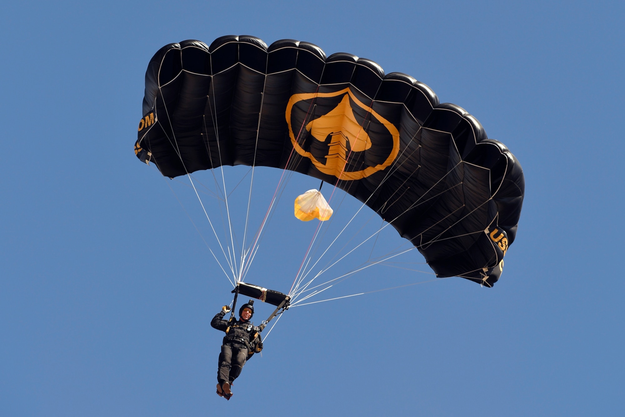 A U.S. Special Operations Command The Para-Commandos parachute demonstration team member parachutes to the ground during the Warriors Over the Wasatch Air and Space Show June 24, 2018, at Hill Air Force Base, Utah. The Para-Commandos are comprised of active duty special operators, such as Army Special Forces, Army Rangers, Navy SEALs, Air Force Combat Controllers and Marine Raiders. (U.S. Air Force photo by Todd Cromar)