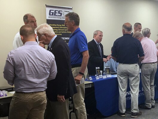 Attendees at Huntsville Center’s fourth Resource Efficiency Manager Workshop speak with industry representative during the technology exposition portion of the two-day event.