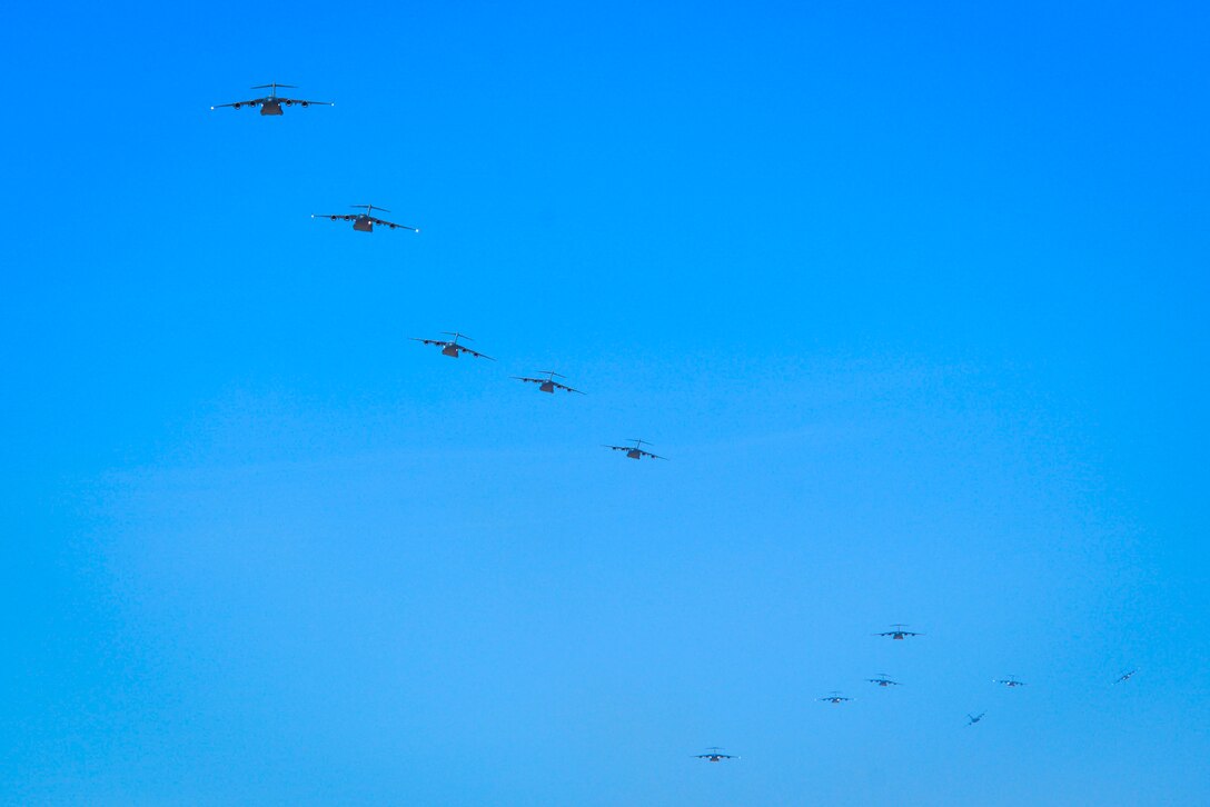 Twelve C-17 Globemaster III assigned to various Air Mobility Command bases in the United States prepare to land at Nellis Air Force Base, Nevada, June 9, 2018. The C-17s participated in Operation Coyote Freedom during the U.S. Air Force Weapons School Integration. (U.S. Air Force photo by Airman Bailee A. Darbasie)