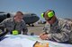 Tech. Sgt. Brandon Vasquez and Master Sgt. Lee Pedersen, both 730th Air Mobility Squadron crew chief, plot out the cordon during an Emergency Response Exercise