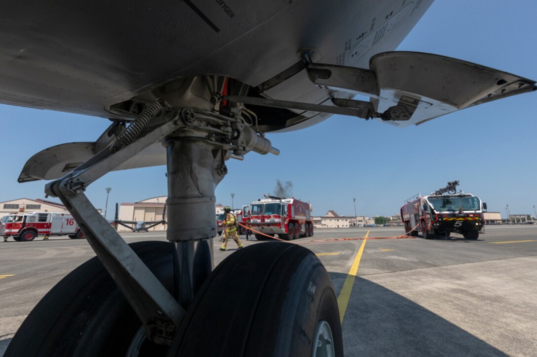 Firefighters with the 374th Civil Engineer Squadron respond to a simulated fire aboard a C-17 Globemaster III during an Emergency Response Exercise