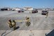 Firefighters with the 374th Civil Engineer Squadron prepare to battle a simulated fire aboard a C-17 Globemaster III during an Emergency Response Exercise