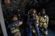 Firefighters from the 374th Civil Engineer Squadron pull a simulated patient from a C-17 Globemaster III cockpit during an Emergency Response Exercise