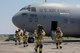 Firefighters with the 374th Civil Engineer Squadron return to the flightline after completing an Emergency Response Exercise