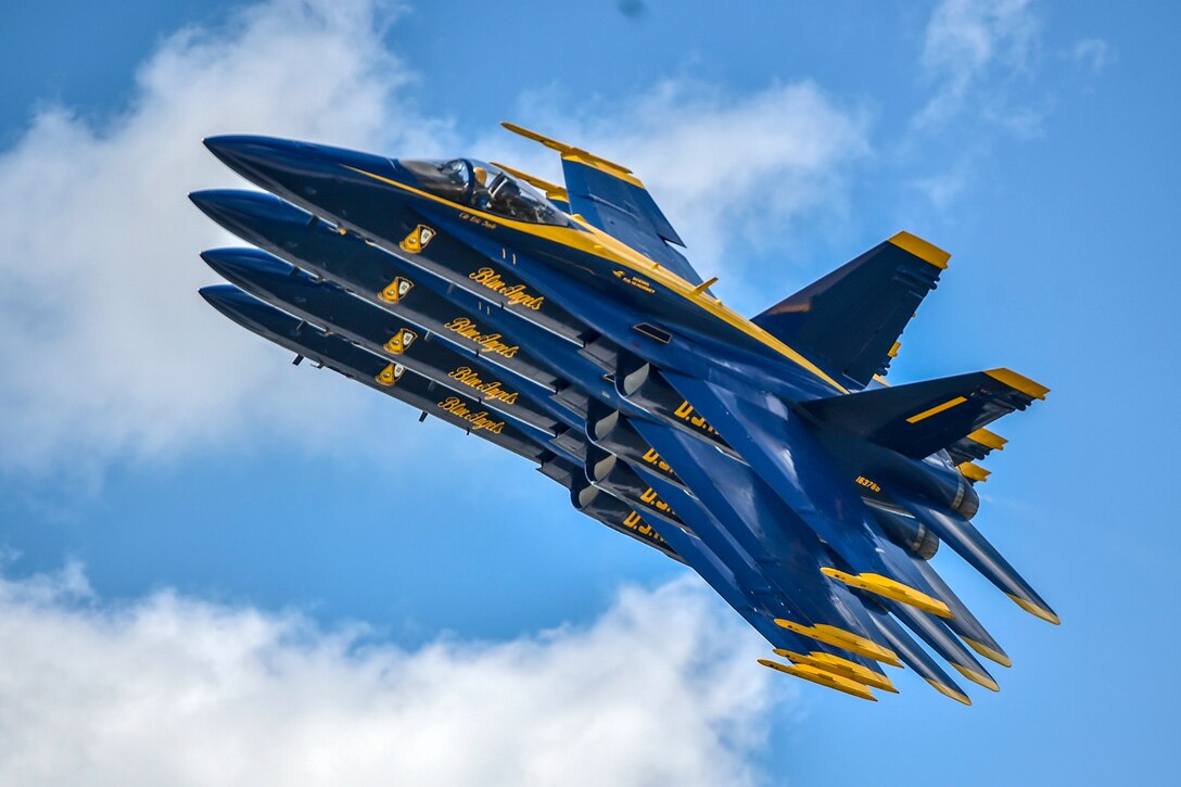 Four aircraft fly in tight formation.