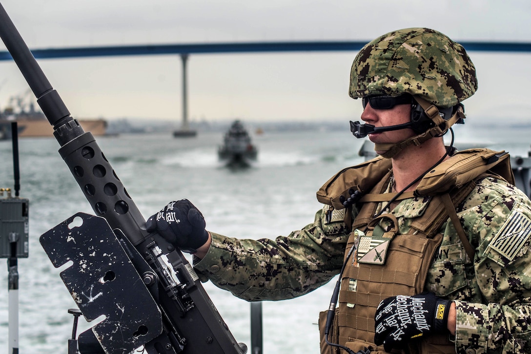 A sailor mans the .50-caliber machine gun aboard Mark VI patrol boat.