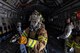 Senior Airman Tianna Cooper, 374th Civil Engieer Squadron firefighter, conducts initial entry of a simulated sire aboard a C-17 Globemaster III