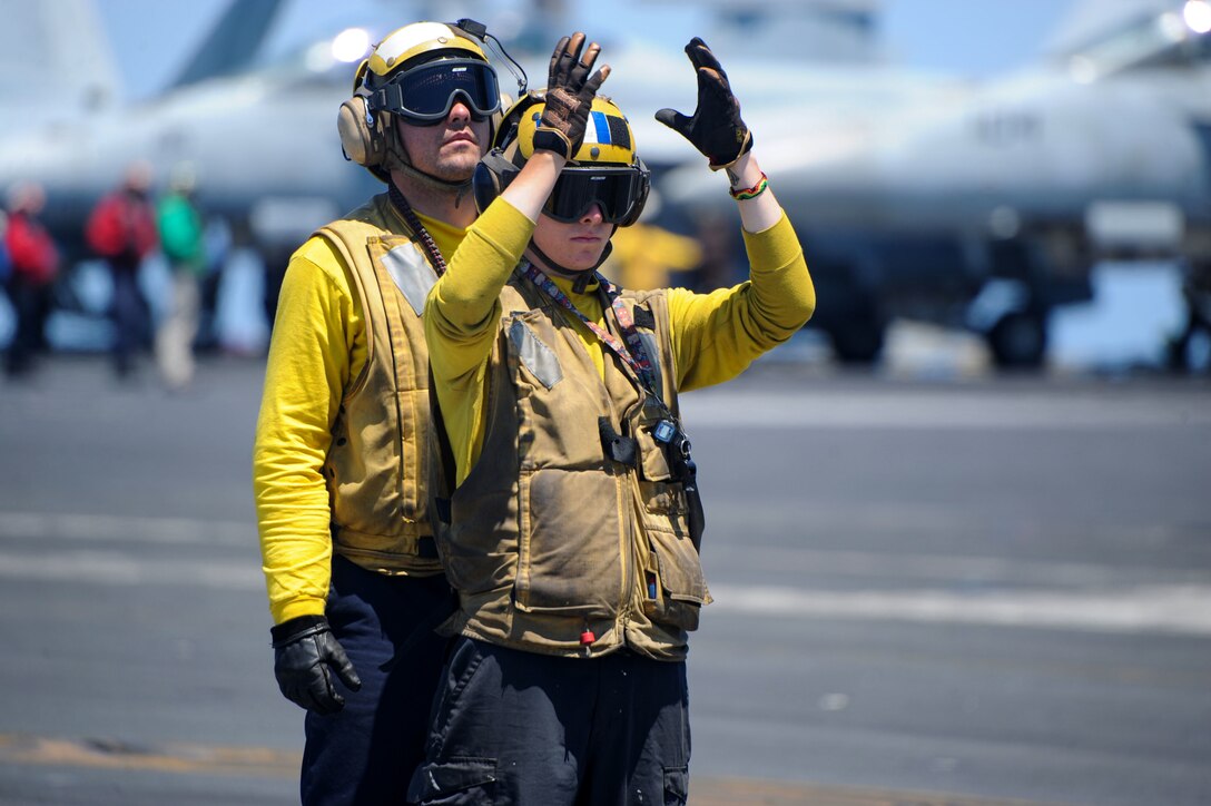Sailors direct aircraft aboard the aircraft carrier USS Harry S. Truman.