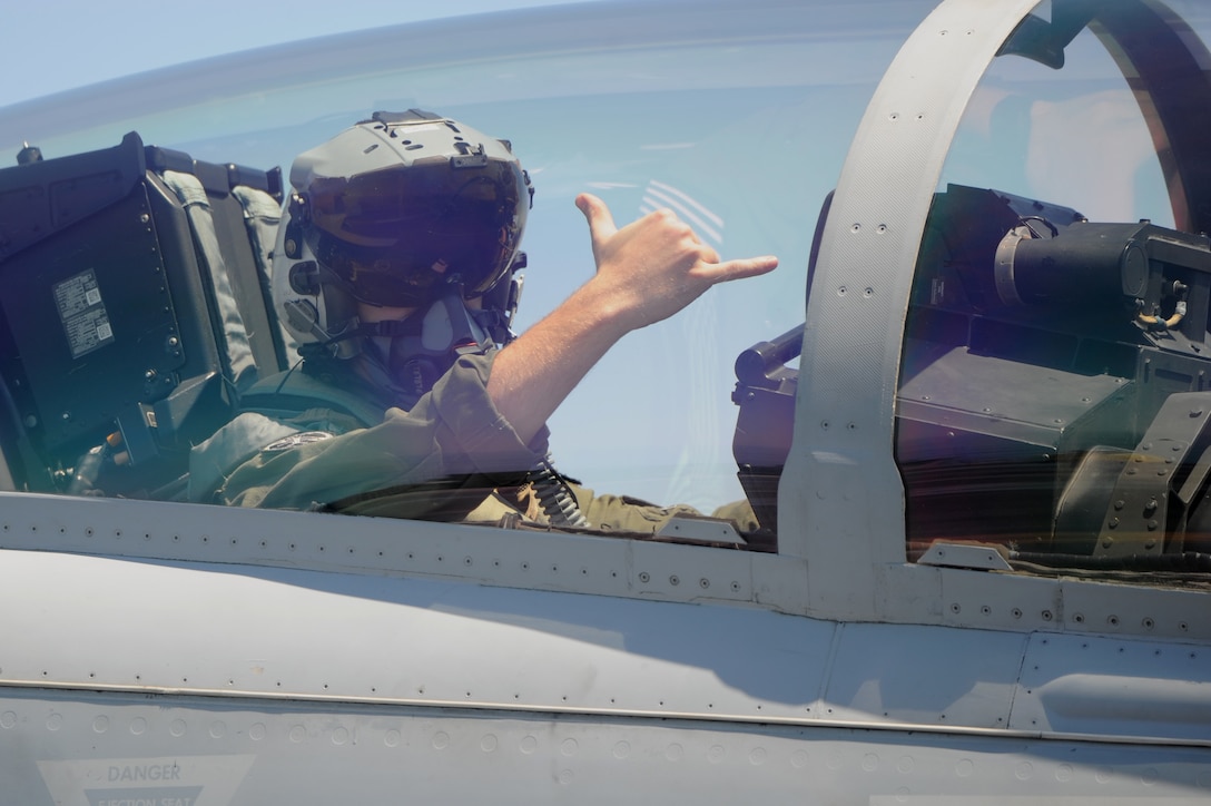 A Navy pilot gives the OK signal as he prepares to launch.