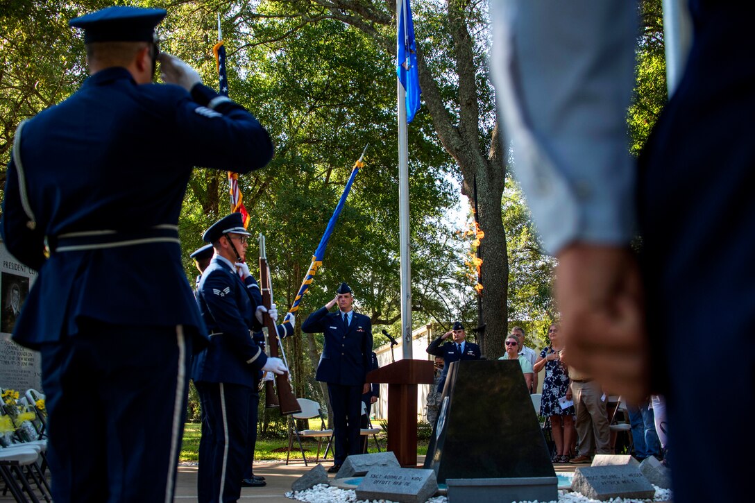 Air Force airmen present the colors at the memorial ceremony.