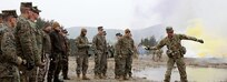 A U.S. Army observer coach/trainer (OC/T) instructs Georgian Army observer coach/trainers (OC/T’s) from the NATO-Georgian Joint Training and Evaluation Center, Hungarian Soldiers, and U.S. Marines on throwing smoke grenades during a Mission Rehearsal Exercise (MRE) at the 7th Army Training Command's Hohenfels Training Area, Hohenfels, Germany, Feb. 7, 2018.
