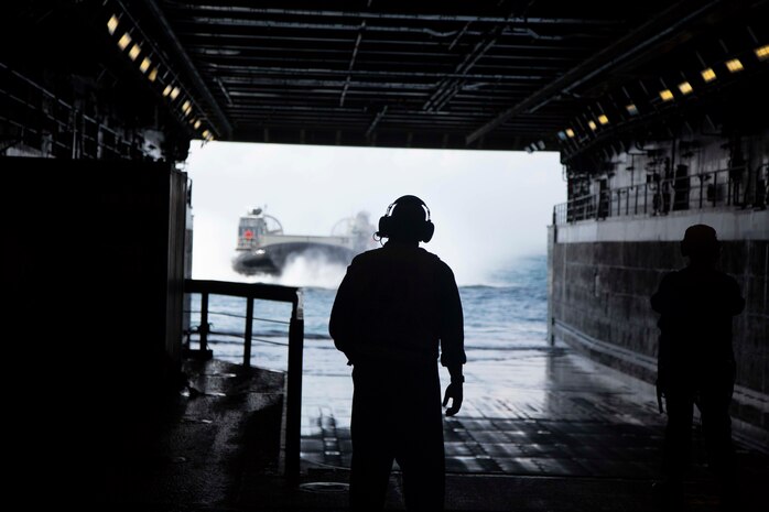 A U.S. Navy landing craft, air cushion with the Assault Craft Unit 4 board the USS Arlington via the well deck during the Amphibious Squadron MEU Integration training in the Atlantic Ocean, June 13, 2018. PHIBRON-MEU Integration is a two-week training evolution that allows Sailors and Marines to train as a cohesive unit in preparation for their upcoming deployment.