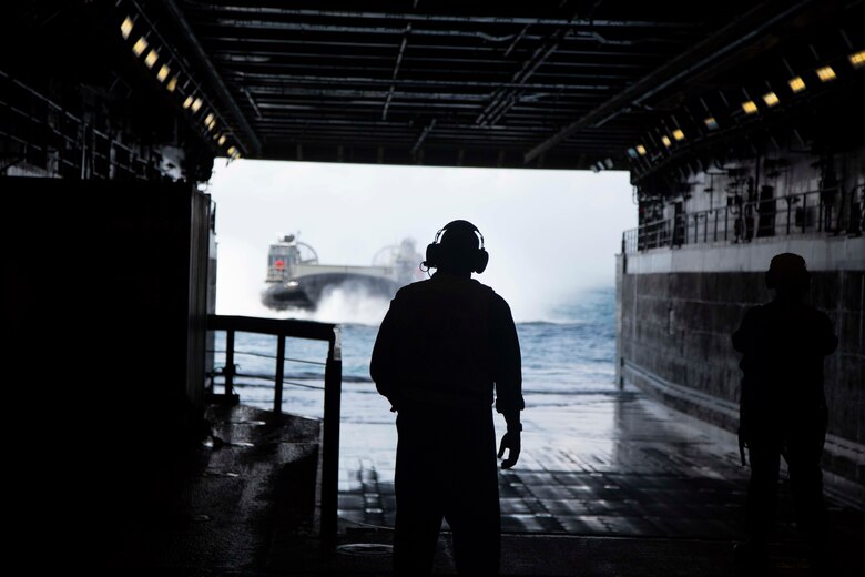 A U.S. Navy landing craft, air cushion with the Assault Craft Unit 4 board the USS Arlington via the well deck during the Amphibious Squadron MEU Integration training in the Atlantic Ocean, June 13, 2018. PHIBRON-MEU Integration is a two-week training evolution that allows Sailors and Marines to train as a cohesive unit in preparation for their upcoming deployment.