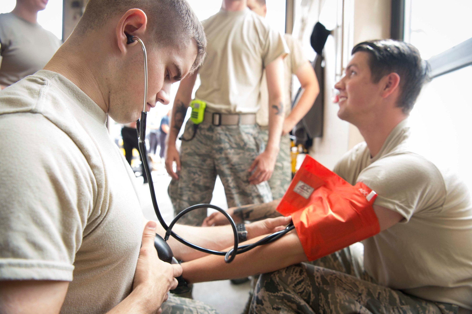 Airmen assigned to the 86th Civil Engineer Squadron Fire Emergency Services take blood pressure measurements during an 86th CES CEF emergency responder training on Ramstein Air Base, June 25, 2018. Medical personnel shared their experience and knowledge with the firefighters, who regularly respond to medical emergency calls. (U.S. Air Force photo by Senior Airman Elizabeth Baker)