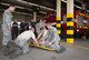 Airmen assigned to the 86th Civil Engineer Squadron Fire Emergency Services practice immobilize and transport a simulated patient during an 86th CES CEF emergency responder training on Ramstein Air Base, June 25, 2018. The 86th Medical Group sent six personnel to train the firefighters in order to keep the firefighters' skills sharp and strengthen the working relationship between the 86th MDG and the fire house, who often respond to medical emergencies together. (U.S. Air Force photo by Senior Airman Elizabeth Baker)