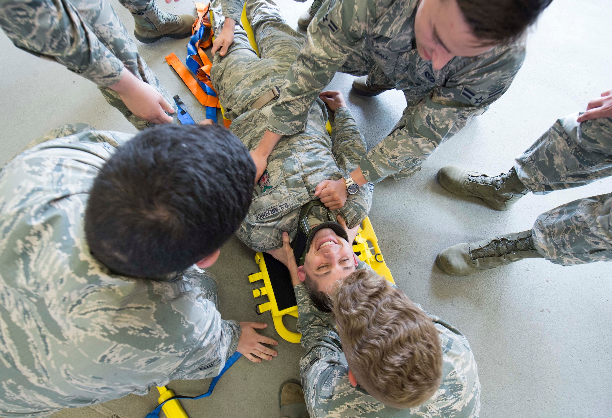 Airmen assigned to the 86th Civil Engineer Squadron Fire Emergency Services practice immobilizing and transporting a patient during an 86th CES CEF emergency responder training on Ramstein Air Base, June 25, 2018. The 86th CES CEF makes emergency responder training as realistic as possible by safely practicing on one another, thereby increasing readiness in the field. (U.S. Air Force photo by Senior Airman Elizabeth Baker)