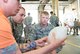 U.S. Air Force Staff Sgts. Jeancarlos Perez Lopez, middle, and Kyle Ledford, right, 86th Civil Engineer Squadron Fire Emergency Services lead firefighters, learn how to use a device to perform assisted breathing during an 86th CES CEF emergency responder training on Ramstein Air Base, June 25, 2018. The 86th Civil Engineer Squadron Fire Emergency Services holds medical trainings to keep personnel proficient in emergency response skills. (U.S. Air Force photo by Senior Airman Elizabeth Baker)