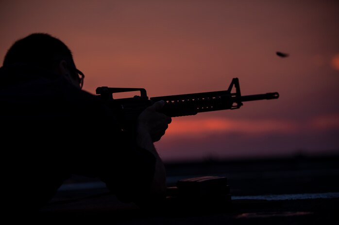 A U.S. Sailor fires an M4 carbine as part of a small arms qualification course on the USS Fort McHenry flight deck during the Amphibious Squadron MEU Integration training in the Atlantic Ocean, June 17, 2018. Enhancing the integration of the Navy-Marine Corps team, PHIBRON-MEU is a two-week training evolution that allows U.S. Sailors and Marines to combine individual and unit skills in preparation for their upcoming deployment.