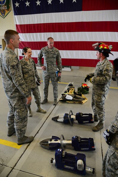 U.S. Air Force Chief Master Sgt. Juliet Gudgel, command chief of Air Education and Training Command, speaks with Staff Sgt. Joshua Kenney, 14th Civil Engineer Squadron station captain, about the various tools used firefighters use to rescue people and protect themselves at Columbus Air Force Base, Mississippi, June 22, 2018. Gudgel toured the 14th CES fire station to see how Airmen work and keep Columbus AFB safe. (U.S. Air Force photo by Airman 1st Class Beaux Hebert)