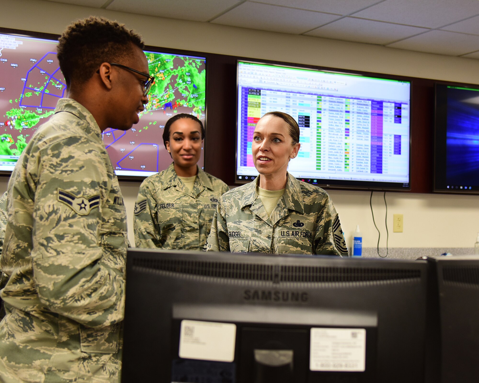 U.S. Air Force Airman 1st Class Rodney Williams, 14th Operations Support Squadron aviation resource manager, talks with Chief Master Sgt. Juliet Gudgel, command chief of Air Education and Training Command, at Columbus Air Force Base, Mississippi, June 21, 2018. Gudgel immersed herself into the 14th Flying Training Wing’s mission by visiting various units around base. (U.S. Air Force photo by Elizabeth Owens)