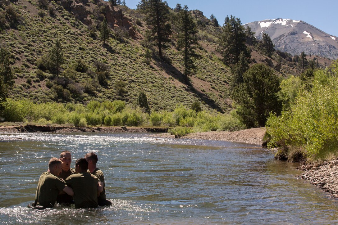 Marines with 2nd Battalion, 24th Marine Regiment, 23rd Marines, 4th Marine Division, cross a stream of rushing water, during Mountain Exercise 3-18, at Mountain Warfare Training Center, Bridgeport, Calif., June 21, 2018.