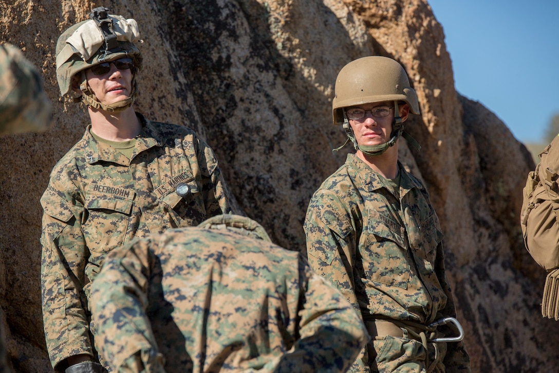 Brandon Beerbohm (left), an assaultman with 2nd Battalion, 24th Marine Regiment, 23rd Marines, 4th Marine Division, and Pfc. James Stuart (right), a combat engineer with 4th Combat Engineer Battalion, 4th MARDIV, wait in line to rappel off a cliff side, during Mountain Exercise 3-18, at Mountain Warfare Training Center, Bridgeport, Calif., June 22, 2018.