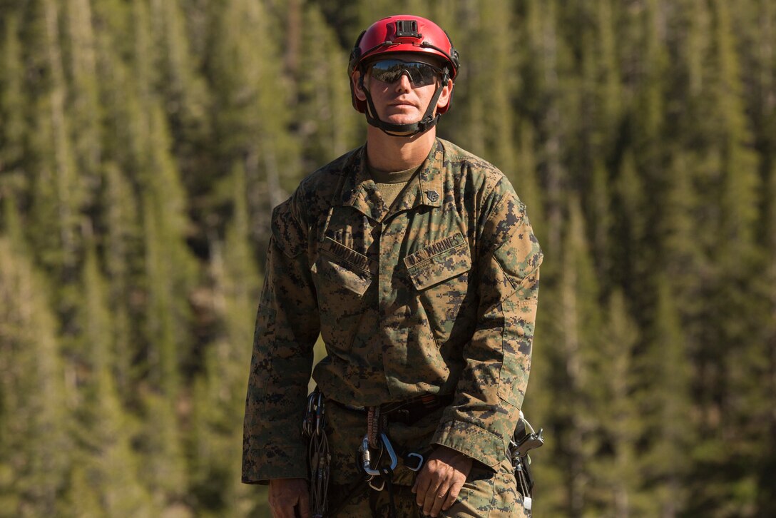 Staff Sgt. Paul Middaugh, an instructor leader with Marine Corps Mountain Warfare Training Center, watches a Marine with 2nd Battalion, 24th Marine Regiment, 23rd Marines, 4th Marine Division, prepare to rappel off a cliffside, during Mountain Exercise 3-18, at MWTC, Bridgeport, Calif., June 20, 2018.