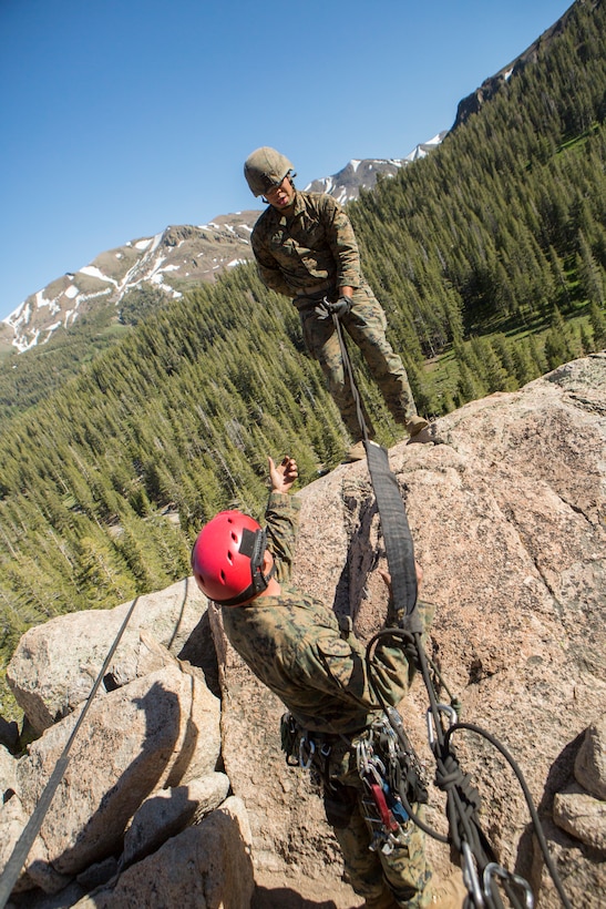 Lance Cpl. Michael Alfaro (top), a mortarman with 2nd Battalion, 24th Marine Regiment, 23rd Marines, 4th Marine Division, begins the descent down a cliffside with the assistance of Staff Sgt. Paul Middaugh (bottom), an instructor leader with Marine Corps Mountain Warfare Training Center, during Mountain Exercise 3-18, at Mountain Warfare Training Center, Bridgeport, Calif., June 22, 2018.