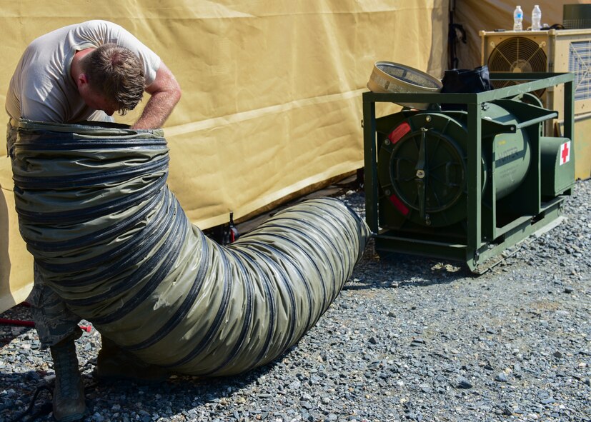 An Expeditionary Medical Systems exercise Airman assembles tent components at Joint Base Langley-Eustis, Virginia, June 20, 2018. A core group on Airmen were trained on tent assembly prior to the exercise and were then tasked with teaching exercise volunteers on the newly learned procedures. (U.S. Air Force photo by Airman 1st Class Monica Roybal)