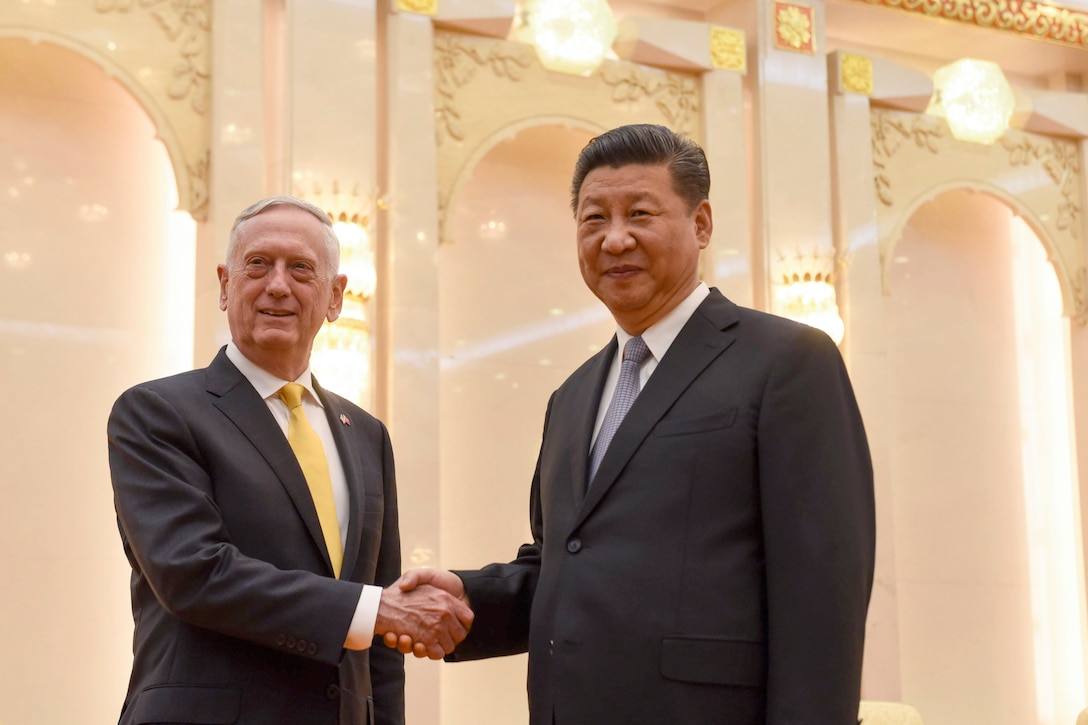 Defense Secretary James N. Mattis shakes hands with Chinese President Xi Jinping in an ornate room with bright lights.