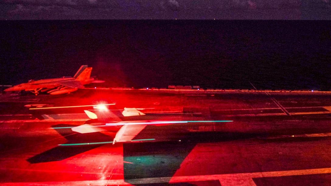 An aircraft takes off from the deck of an aircraft carrier.