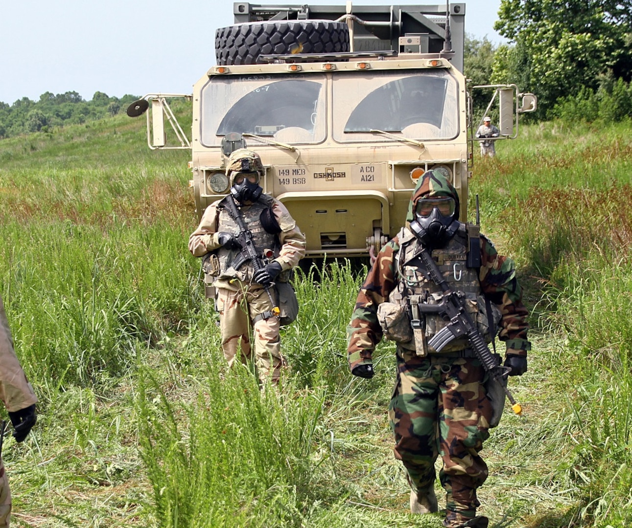 Soldiers with the 149th Brigade Support Battalion guide their vehicles to a decontamination site during an exercise at the Wendell H. Ford Regional Training Center in Greenville, Ky., June 19, 2018. More than 1,000 Soldiers of the 149th Maneuver Enhancement Brigade participated in a modified annual training to test the interoperability of units within the brigade in a fully operational environment.