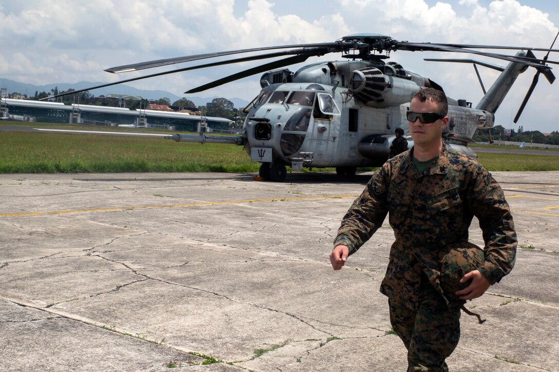 Marine Corps Sgt. Erik Demay, Marine Corps Community Services chief, walks off the flight line to check into the immigration office in Guatemala City.