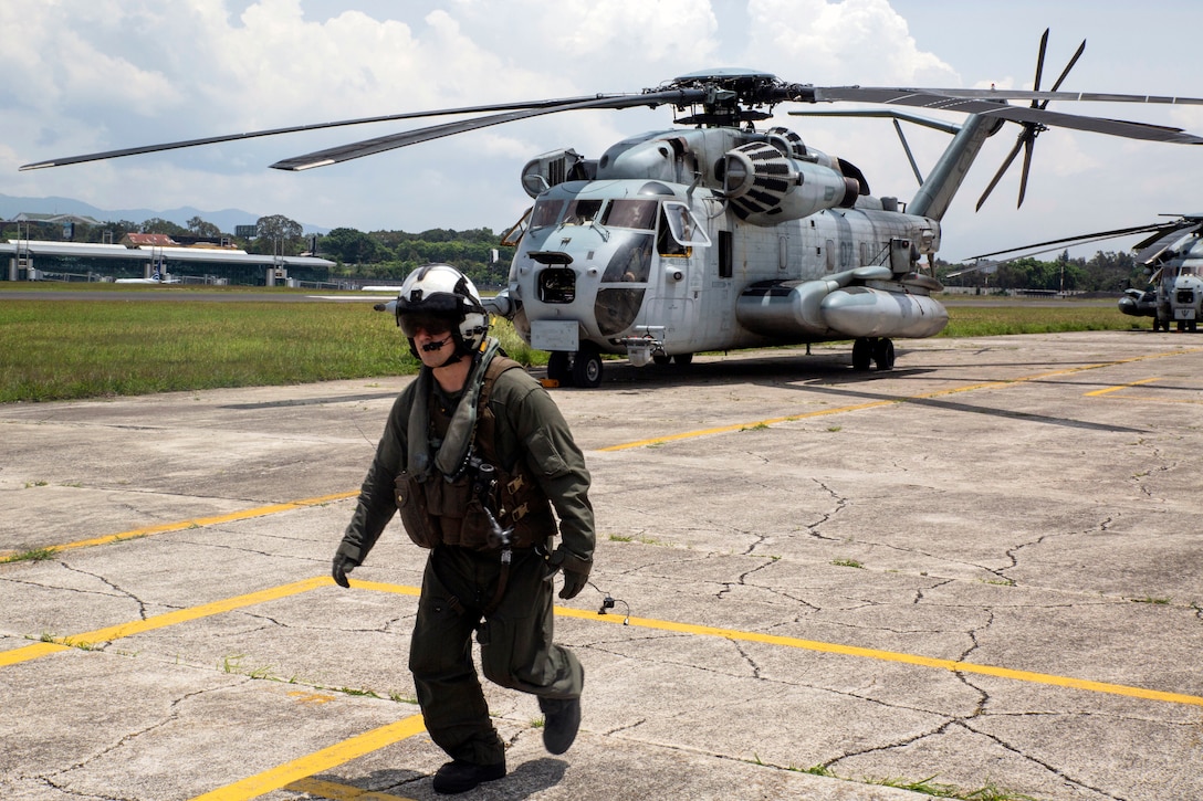 Marine Lance Cpl. Luke Rhysdahl walks off the flight line to check into the immigration office.