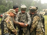 Oscar Hernandez, second from lef), a training specialist from the U.S. Army Space and Missile Defense Agency, guides Ohio Army National Guard Soldiers from the 1487th Transportation Company on how to detect electromagnetic interference on an AN/PSN-13 Defense Advanced GPS Receiver (DAGR) June 23, 2018, during annual training at Camp Grayling Joint Maneuver Training Center in Grayling, Mich. This training provides Soldiers guidance in the event they encounter a contested electronic warfare environment.